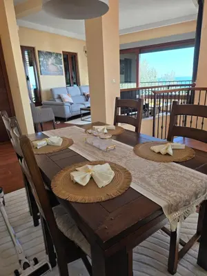 a wooden table with napkins on it in a living room at Vista Blue Villa in Budva
