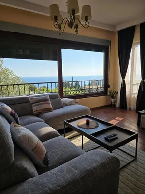 a living room with two couches and a table at Vista Blue Villa in Budva