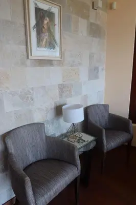 a living room with two chairs and a table with a lamp at Vista Blue Villa in Budva