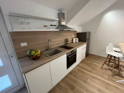 a kitchen with a sink and a counter top at Petra & Vuk Apartments Kotor in Kotor