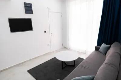 a living room with a couch and a table at Diamonds Xh&A Apartments in Ulcinj
