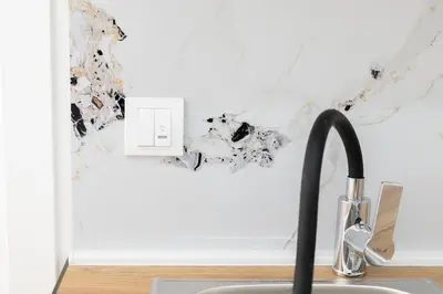 a sink in a kitchen with a white wall at Diamonds Xh&A Apartments in Ulcinj