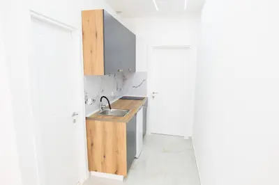 a kitchen with a sink next to a door at Diamonds Xh&A Apartments in Ulcinj