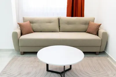 a living room with a couch and a white table at Diamonds Xh&A Apartments in Ulcinj