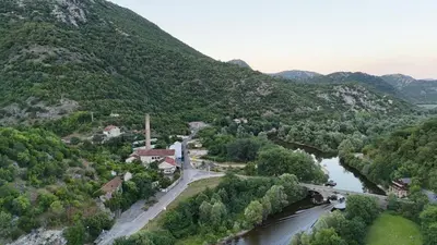a view of a valley with a river and a bridge at Riječki grad Apartments in Rijeka Crnojevića