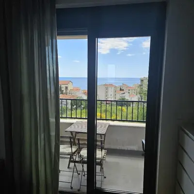 a balcony with a table and a view of the ocean at Apartament Onyx in Becici