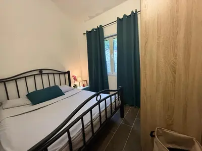 a bedroom with a bed and a window at Golden Ray Bigova in Bigovo