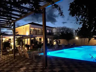 a house with a swimming pool at night at Andrej home in Šušunja