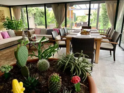 a living room with a table and chairs and plants at Andrej home in Šušunja