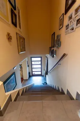 a stairway in a house with a hallway with a door at Andrej home in Šušunja