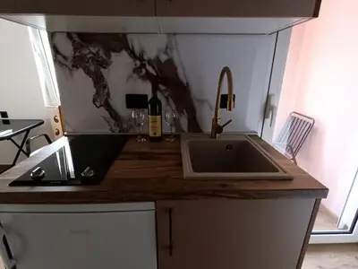 a kitchen with a sink and a counter top at ApartmentsMD apartman 1 za pravi odmor in Sutomore