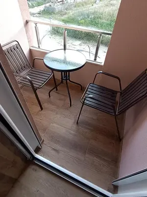 a balcony with a table and two chairs and a window at ApartmentsMD apartman 1 za pravi odmor in Sutomore