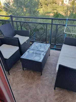 a patio with chairs and tables on a balcony at Apartman OAZA 4 in Ulcinj