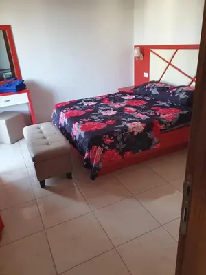 a bedroom with a bed and a couch and a chair at Apartman OAZA 4 in Ulcinj