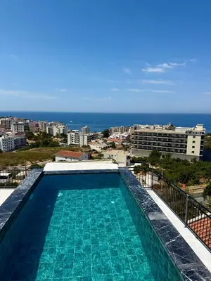 a swimming pool with a view of the ocean at Harmonia in Dobra Voda