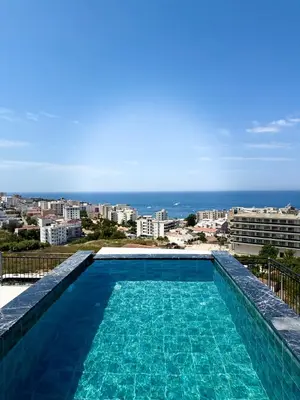 a swimming pool with a view of the ocean at Harmonia in Dobra Voda