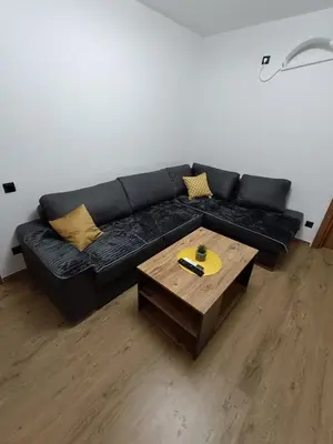 a black couch in a living room with a coffee table at ApartmentsMD apartment 3 for real enjoyment in Sutomore