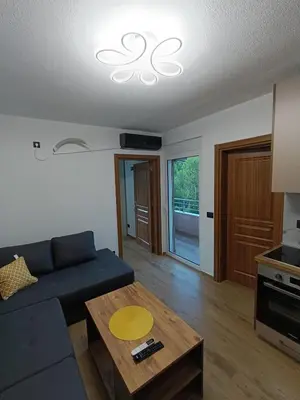 a living room with a blue couch and a table at ApartmentsMD apartment 3 for real enjoyment in Sutomore