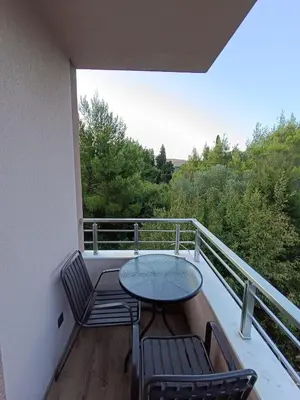 a balcony with a table and chairs on a balcony at ApartmentsMD apartment 3 for real enjoyment in Sutomore