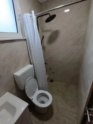 a bathroom with a toilet and a shower and a sink at ApartmentsMD apartment 3 for real enjoyment in Sutomore