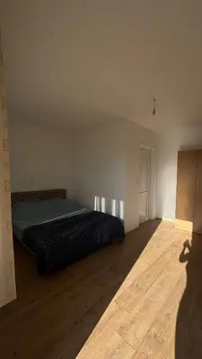 a bedroom with a bed and a wooden floor at Apparteman in Ulcinj