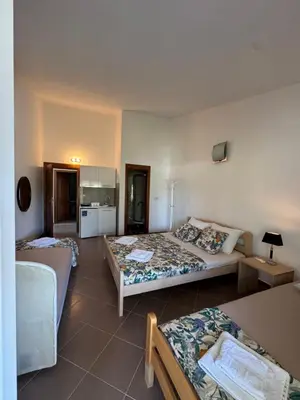 a hotel room with two beds and a kitchen at Apartmani Sutomore in Sutomore
