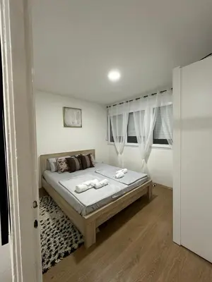 a bedroom with a bed with two towels on it at Zagi Apartment in Ulcinj