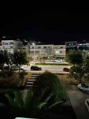 a parking lot at night with cars parked in a parking lot at Zagi Apartment in Ulcinj