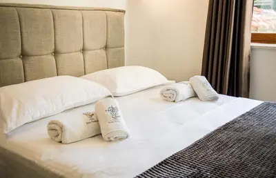 a bed with towels and pillows on it at Villa Terra Promessa in Ulcinj