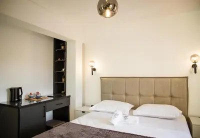 a bedroom with a bed and a dresser and a bed sidx sidx sidx sidx at Villa Terra Promessa in Ulcinj