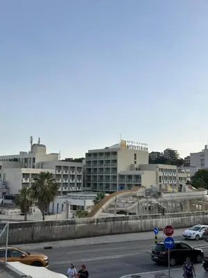a city street with cars and buildings in the background at Atlantic-Moj market in Boreti