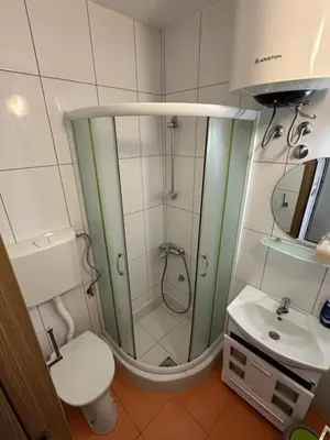 a bathroom with a shower and a toilet and a sink at Atlantic-Moj market in Boreti