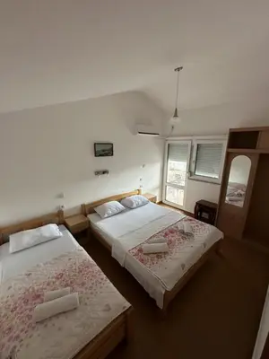 a bedroom with two beds and a window at Atlantic-Moj market in Boreti
