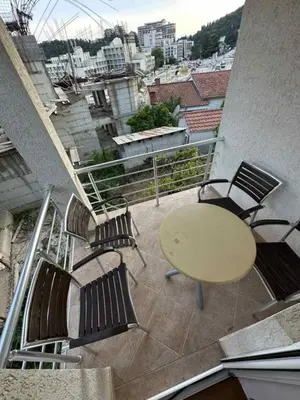 a patio with a table and chairs on a balcony at Atlantic-Moj market in Boreti