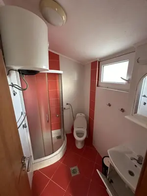 a small bathroom with a toilet and a sink at Atlantic-Moj market in Boreti