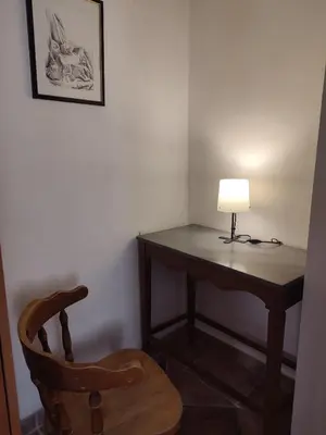 a desk with a lamp and a wooden chair at Radimir 101 in Kotor
