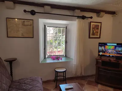 a living room with a television and a window at Radimir 101 in Kotor