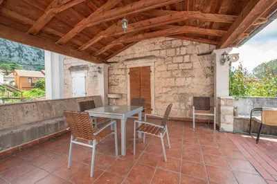 a room with a table and chairs on a patio at Radimir 101 in Kotor