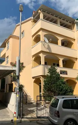 a building with a car parked in front of it at Villa Nova in Budva