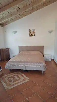 a bedroom with a bed in a white wall at Villa Nova in Budva
