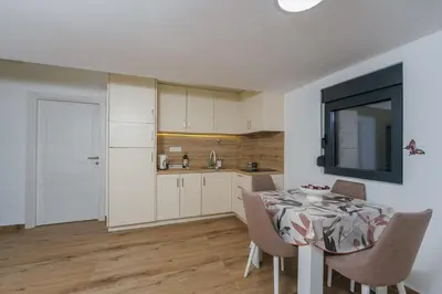 a kitchen and dining room with a table and chairs at Monte Bay Apartments in Kotor