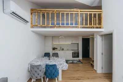 a kitchen and dining room with a table and chairs at Monte Bay Apartments in Kotor