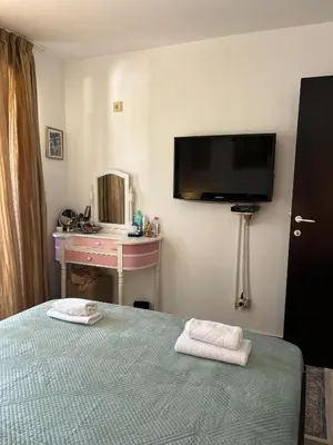 a bedroom with a bed and a tv on the wall at Teuta Azure Apartment - Blue Horizont Complex, Sveti Stefan in Pržno