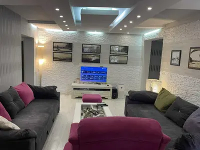 a living room with a couch and a tv at Apart 102 in Kućišta