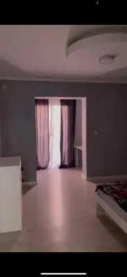 an empty room with a bed and a window at Apart 102 in Kućišta