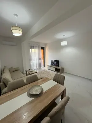 a living room with a table and a couch at FB Apartments in Ulcinj
