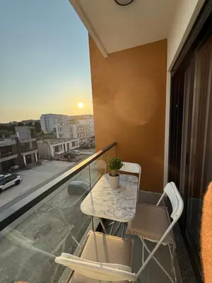 a balcony with a table and a plant on it at FB Apartments in Ulcinj
