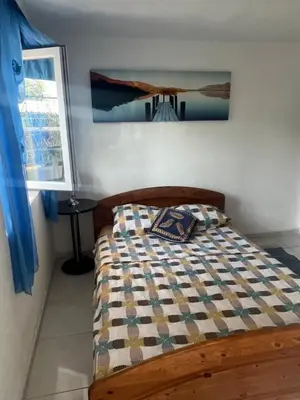 a bed with a quilt on it in a bedroom at Apartmani Amira Sutomore in Sutomore