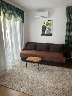 a living room with a couch and a table at Apartmani Amira Sutomore in Sutomore