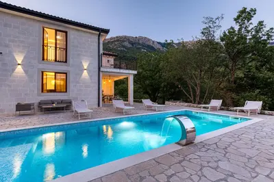a swimming pool in front of a house at Villa 53 in Lapčići